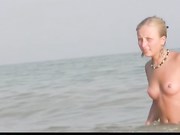 Barely legal young nudist lays naked at the beach