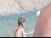 French nudist beach Cap d'Agde brunette plays dick handjob