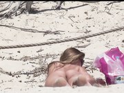 Stunning well-equiped blond girl enjoy the nude beach